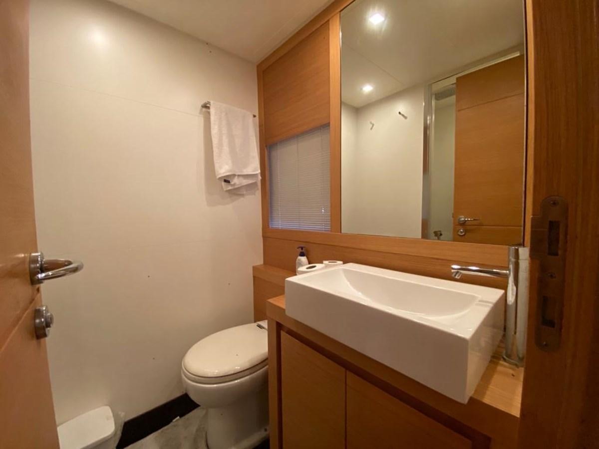a bathroom with a sink toilet and a mirror aboard PERSHING 64 Yacht for Sale