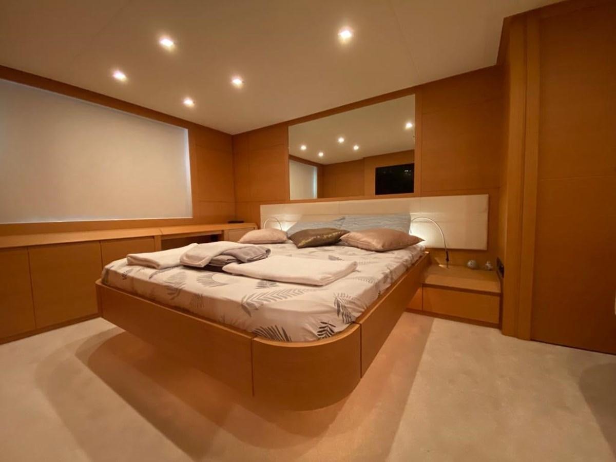 a room with a bed and a mirror aboard PERSHING 64 Yacht for Sale
