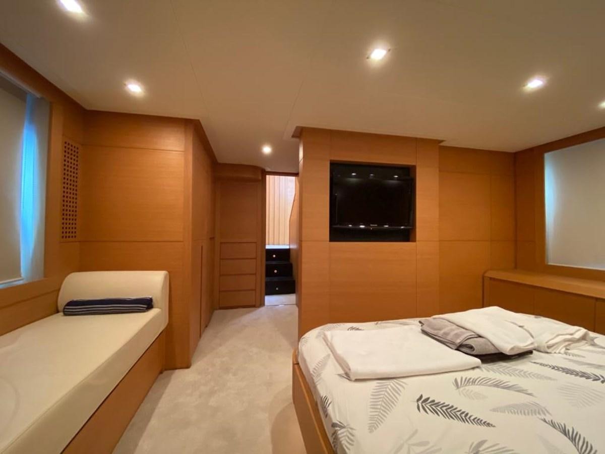 a room with a bed and a tv aboard PERSHING 64 Yacht for Sale
