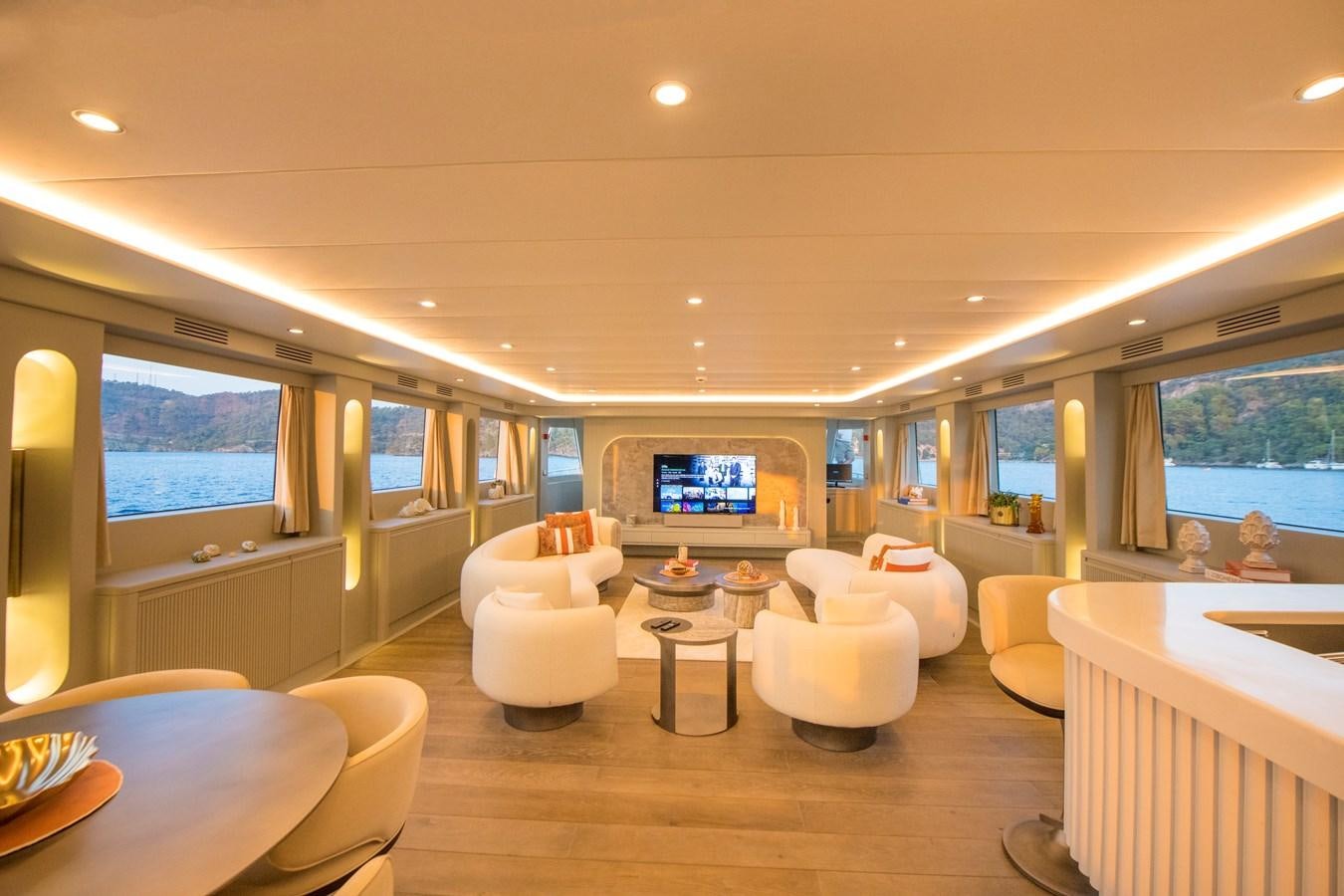 a room with a table chairs and a tv aboard MOTORSAILOR 41M Yacht for Sale