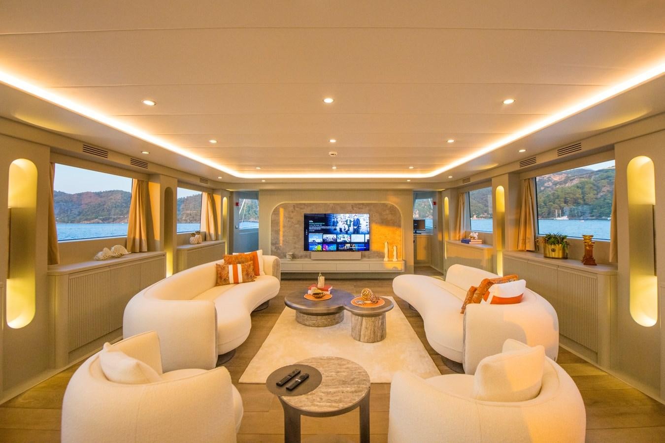 a living room with a large screen aboard MOTORSAILOR 41M Yacht for Sale