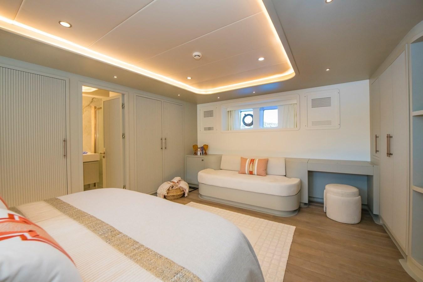 a bedroom with a bed and a couch aboard MOTORSAILOR 41M Yacht for Sale