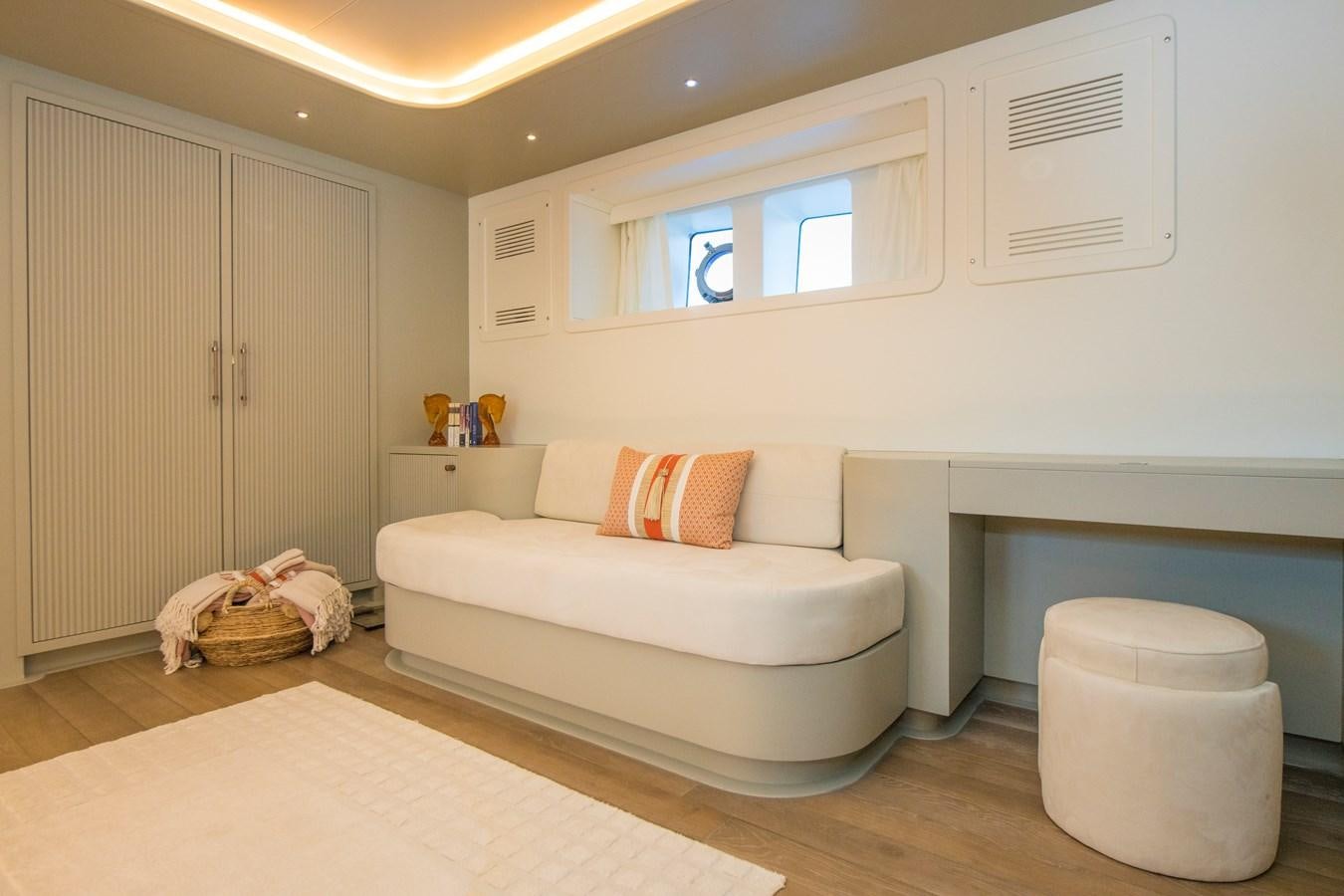 a room with a bed and a chair aboard MOTORSAILOR 41M Yacht for Sale