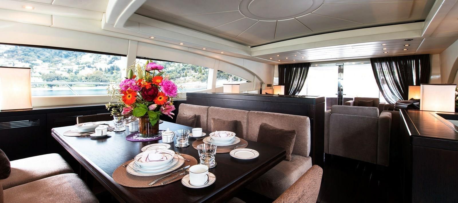 a table with plates and cups on it aboard BLOOMS Yacht for Sale