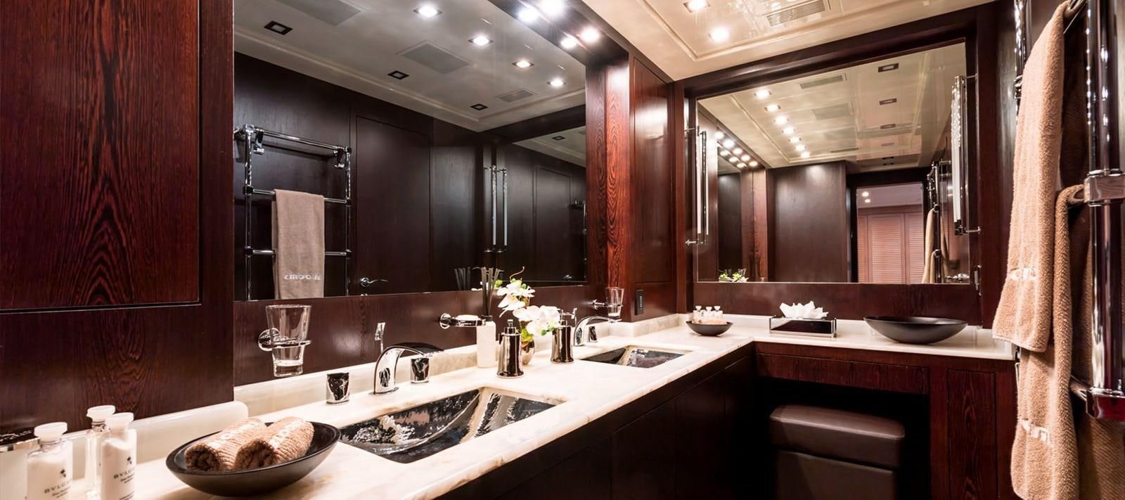 a bathroom with sinks and mirrors aboard BLOOMS Yacht for Sale