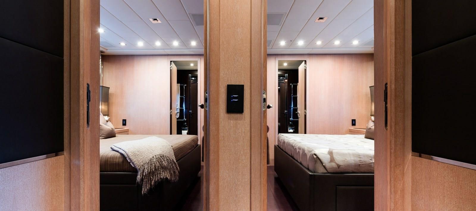 a room with a bed and a mirror aboard BLOOMS Yacht for Sale
