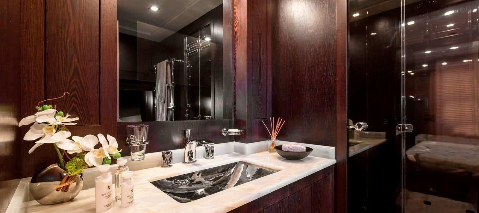 a bathroom with a sink and a mirror aboard BLOOMS Yacht for Sale