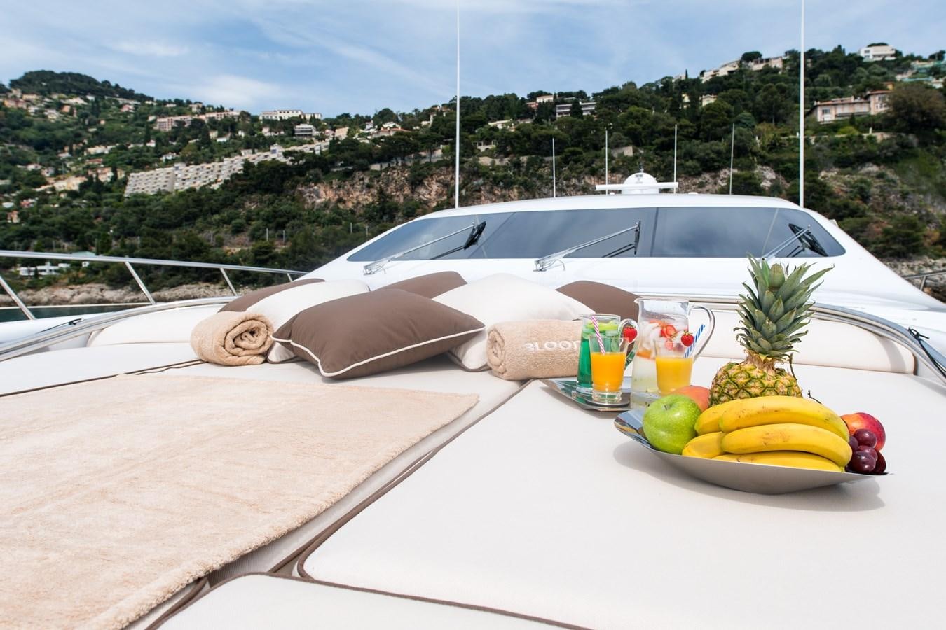 a white convertible car on a white table with a white tablecloth and a white convertible car with aboard BLOOMS Yacht for Sale