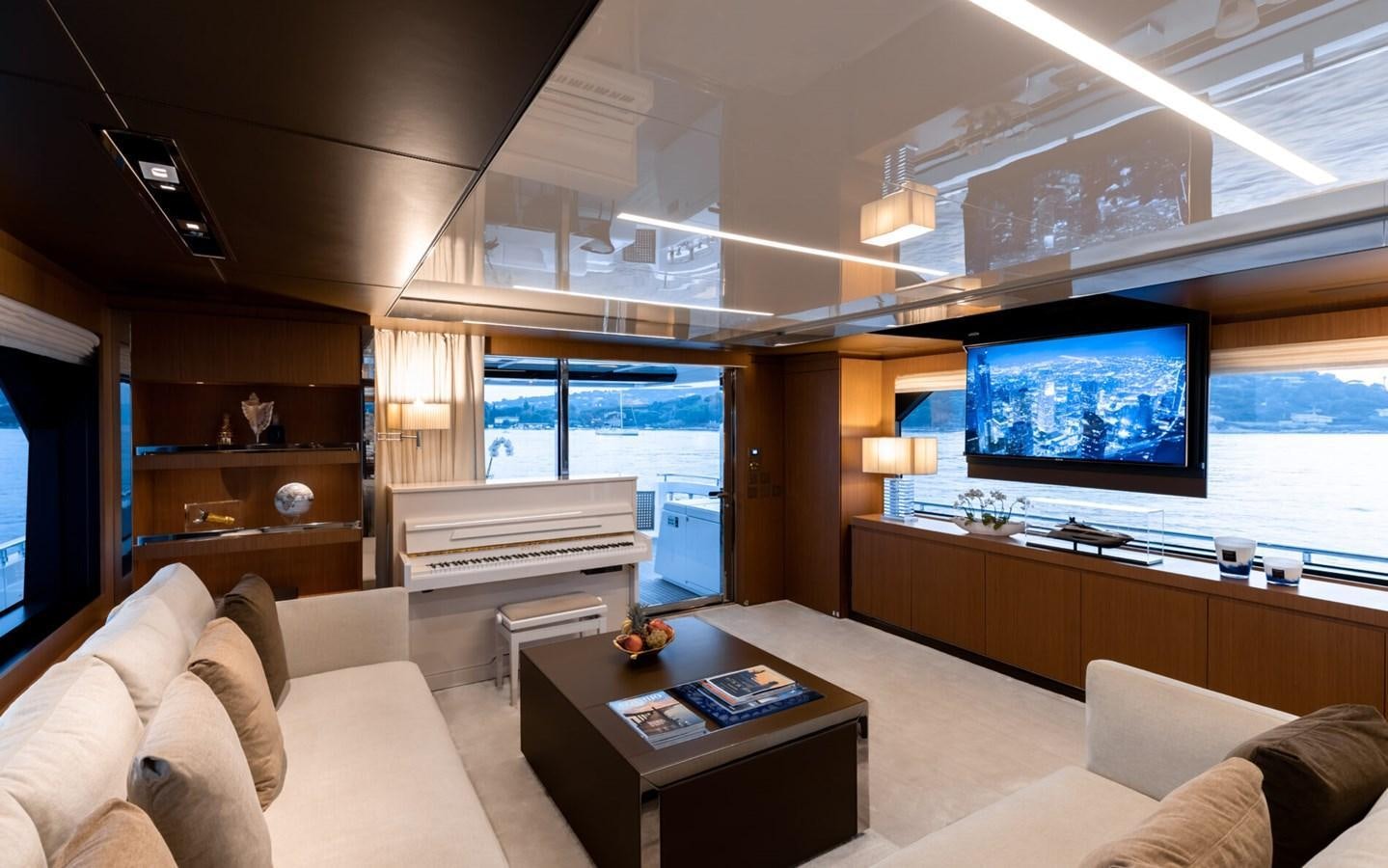 a living room with a large screen aboard RAPH SEVEN II Yacht for Sale