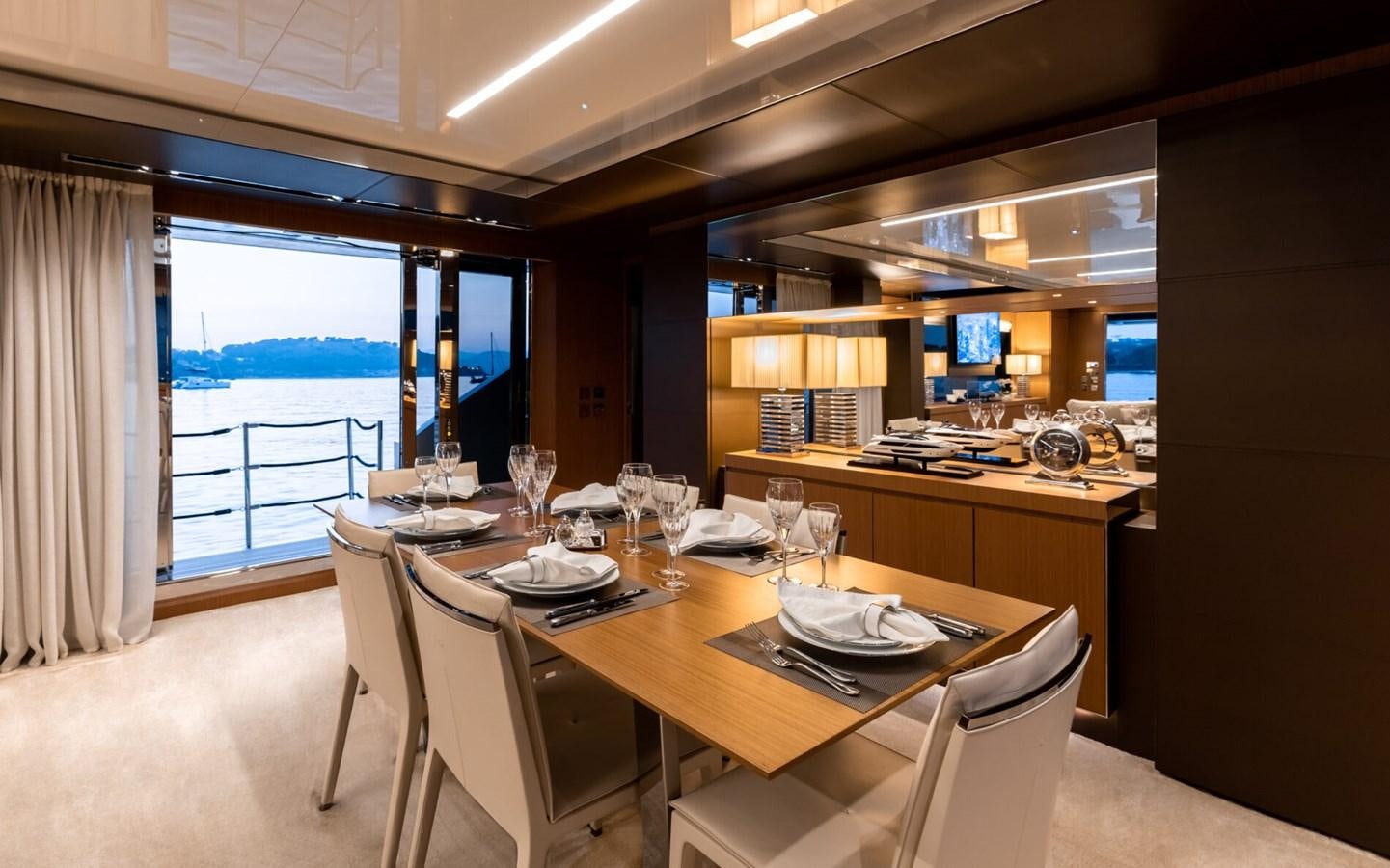 a table with plates and chairs aboard RAPH SEVEN II Yacht for Sale