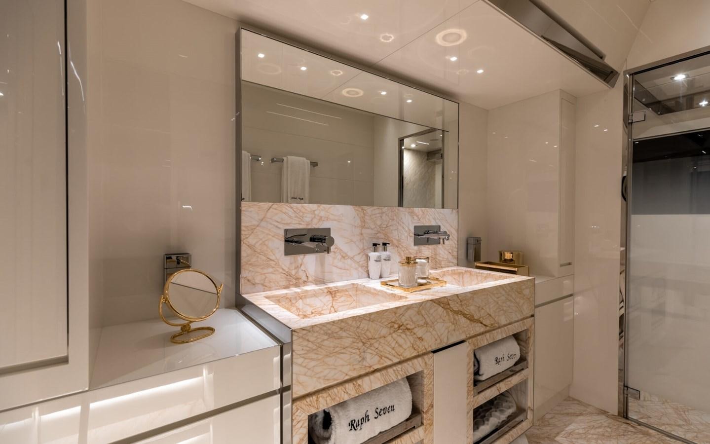 a bathroom with a countertop sink and mirror aboard RAPH SEVEN II Yacht for Sale