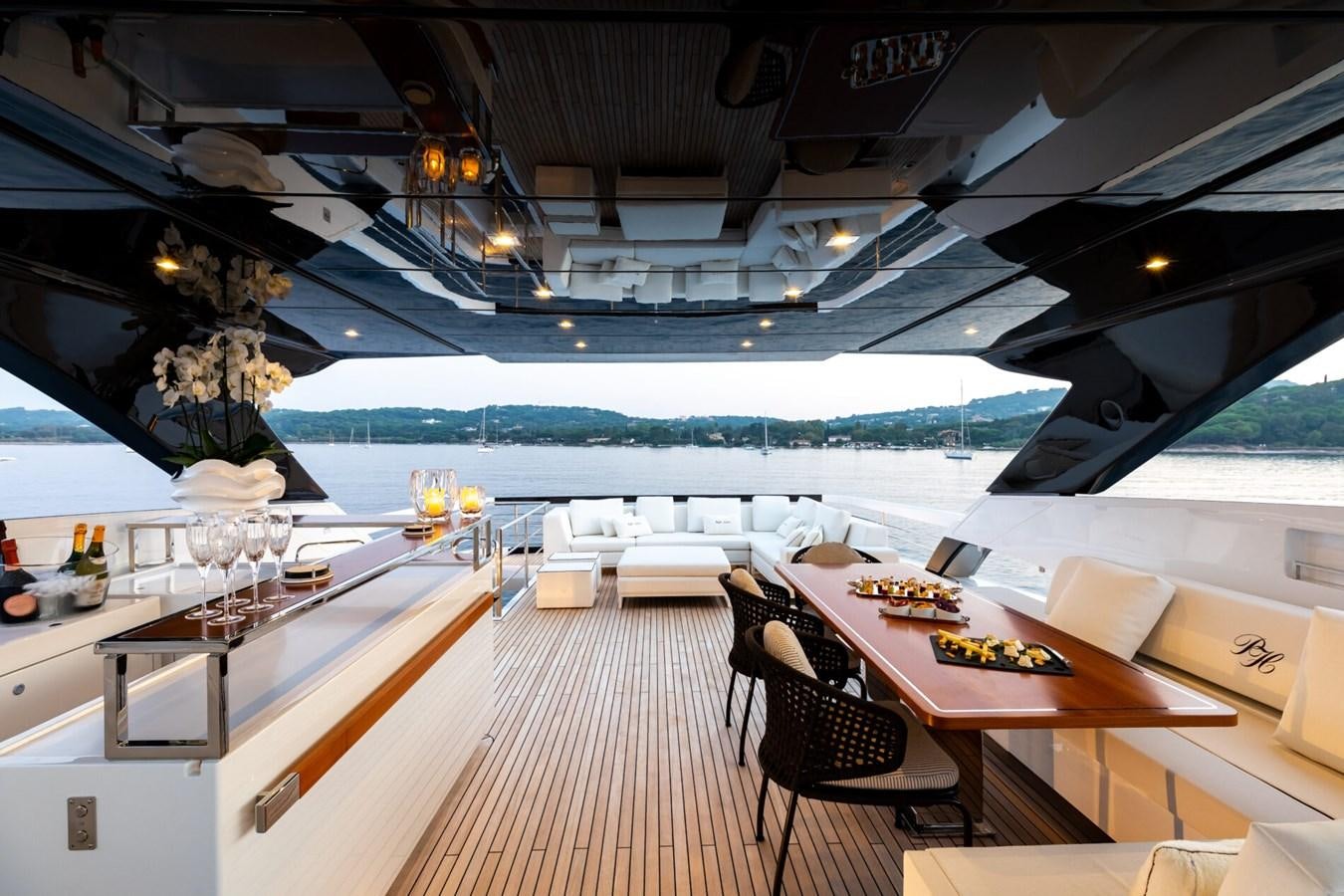 a room with tables and chairs aboard RAPH SEVEN II Yacht for Sale
