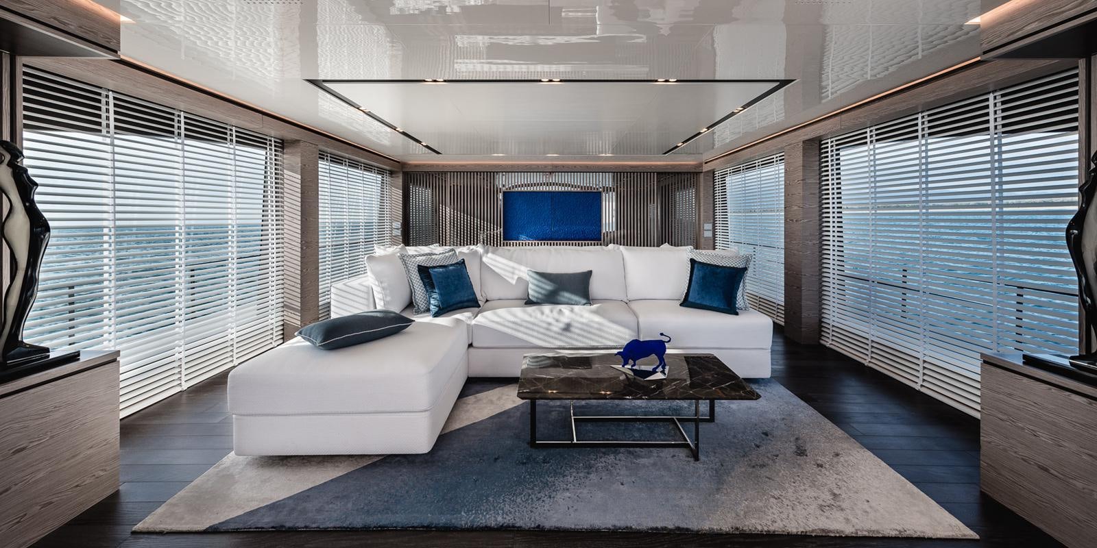 a living room with a couch and a coffee table aboard ZOUT Yacht for Sale