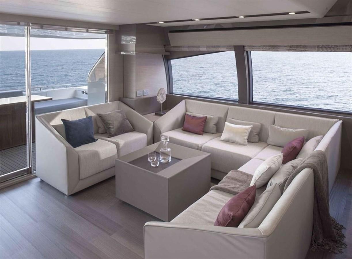 a living room with a large window aboard AMO Yacht for Sale
