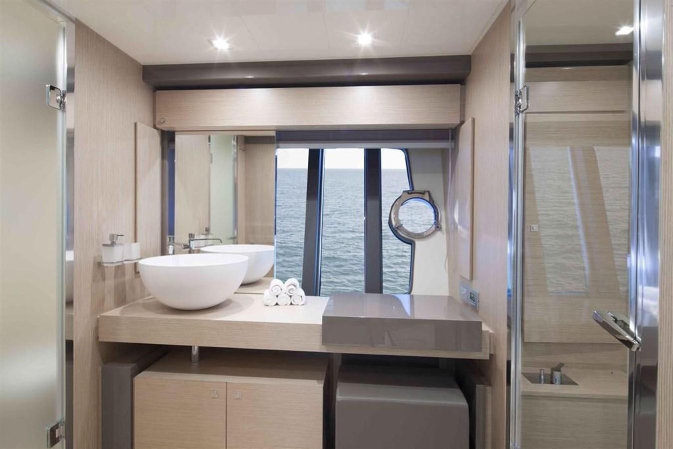 a bathroom with a sink and a large window aboard AMO Yacht for Sale