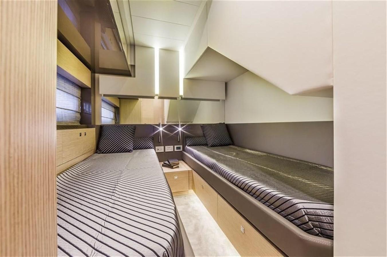 a room with a bed and a desk aboard AMO Yacht for Sale