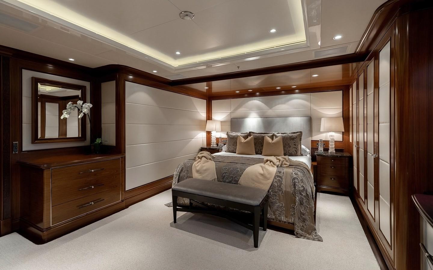 a bedroom with a bed and a mirror aboard SEANNA Yacht for Sale