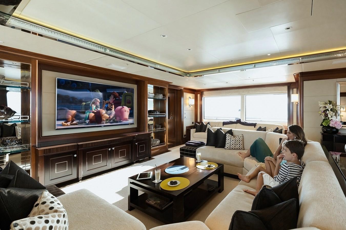a couple of people watching a television aboard SEANNA Yacht for Sale
