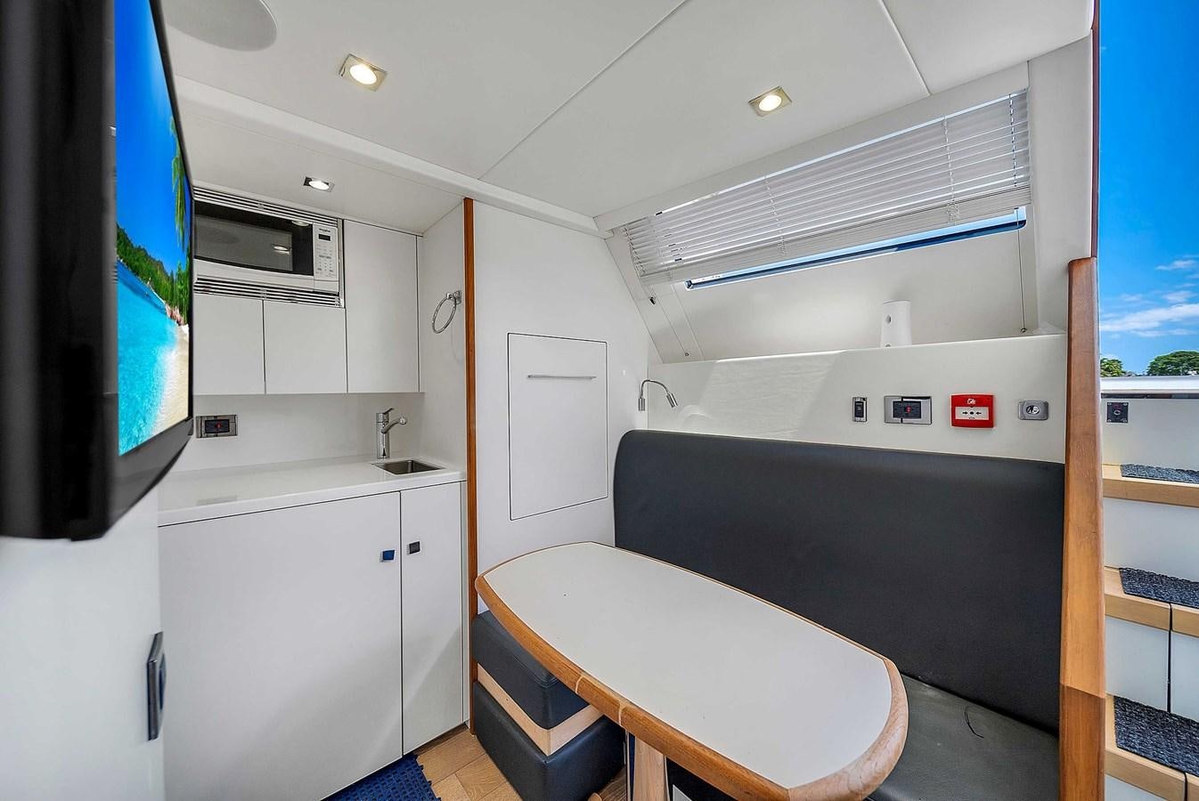 a room with a table and a tv aboard 86 Yacht for Sale