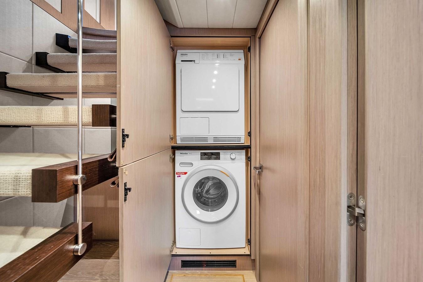 a white washing machine in a room aboard 86 Yacht for Sale