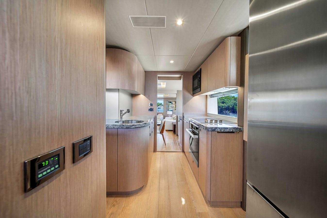 a kitchen with a large refrigerator aboard 86 Yacht for Sale