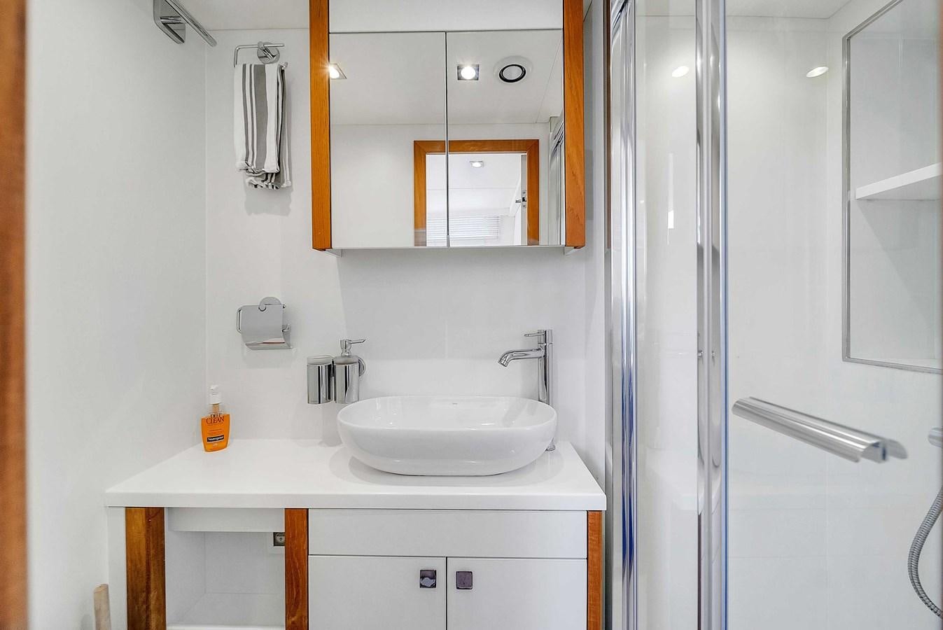 a bathroom with a sink and mirror aboard 86 Yacht for Sale