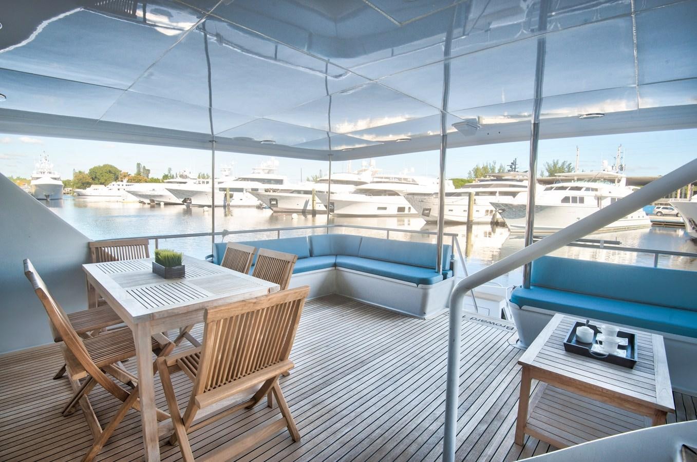 a deck with a pool and a deck with chairs and tables aboard DESLIZE Yacht for Sale
