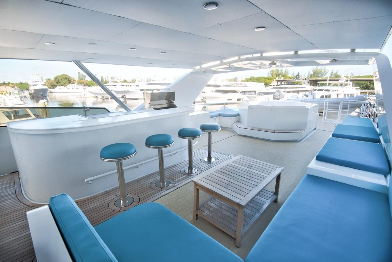 a room with a pool table and stools aboard DESLIZE Yacht for Sale