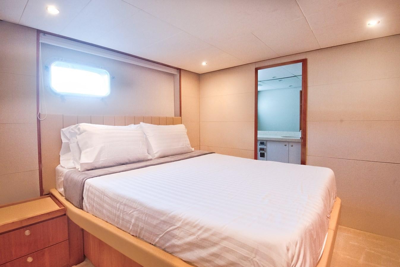 a bed with white sheets aboard DESLIZE Yacht for Sale