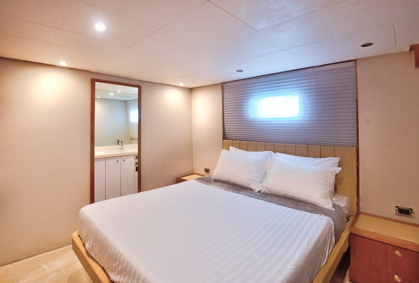 a room with a bed and a mirror aboard DESLIZE Yacht for Sale