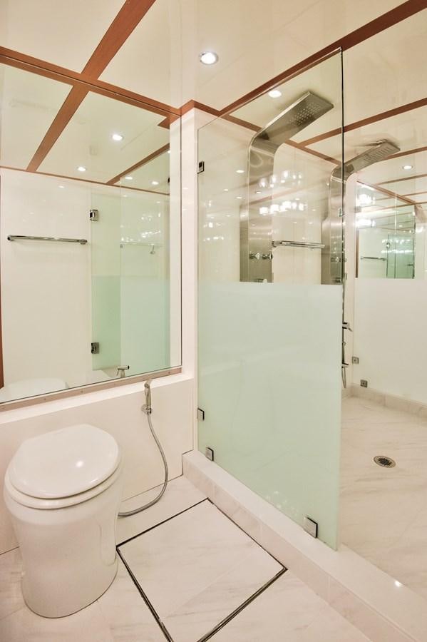a bathroom with a toilet and a mirror aboard DESLIZE Yacht for Sale