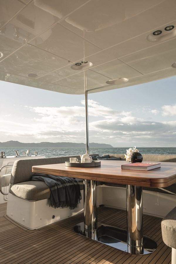 a room with a table and a bed aboard 2023 MAGELLANO 66 Yacht for Sale