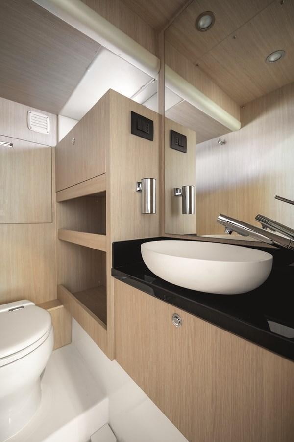 a bathroom with a sink and toilet aboard 2023 MAGELLANO 66 Yacht for Sale