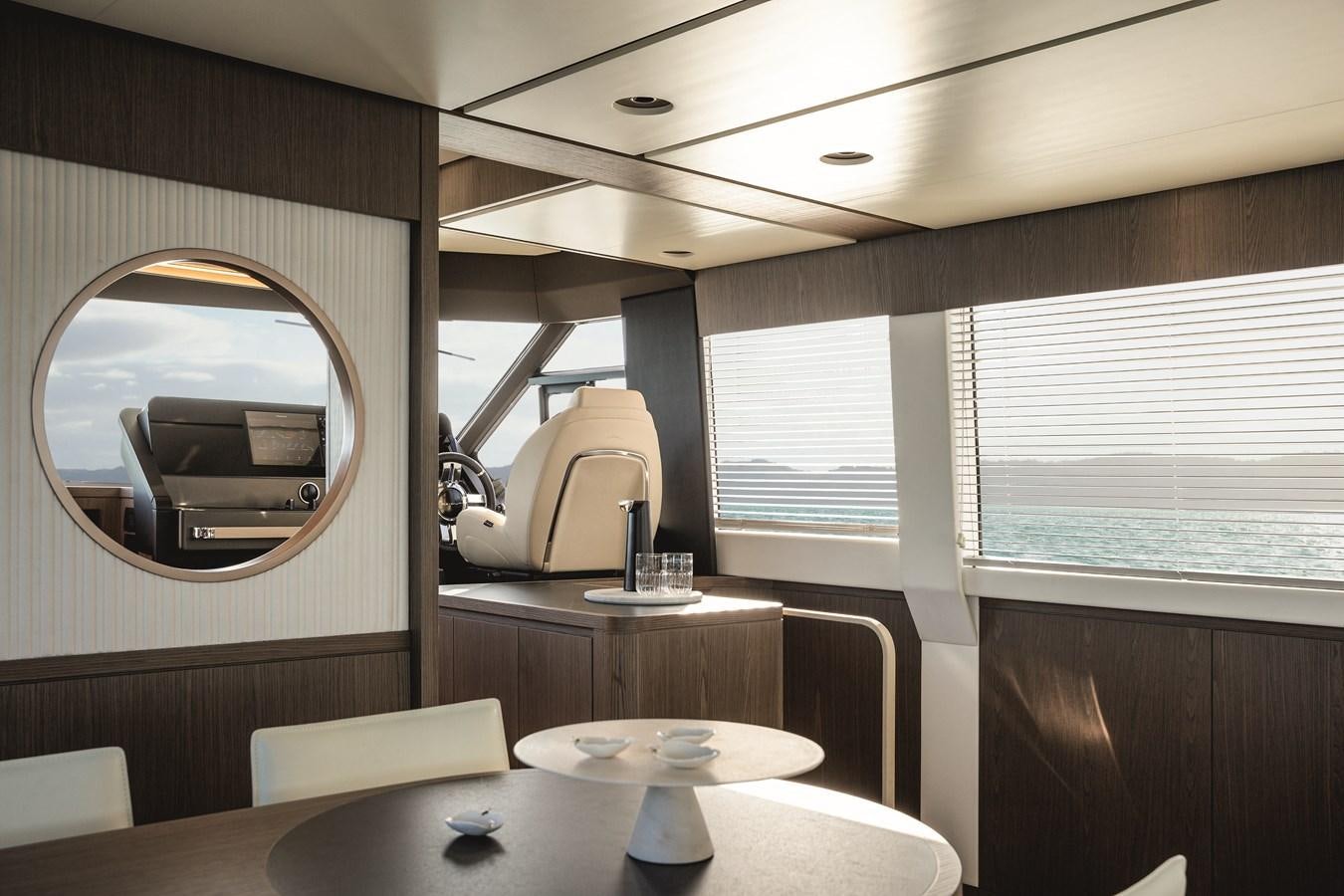 a room with a table and chairs aboard 2023 MAGELLANO 66 Yacht for Sale
