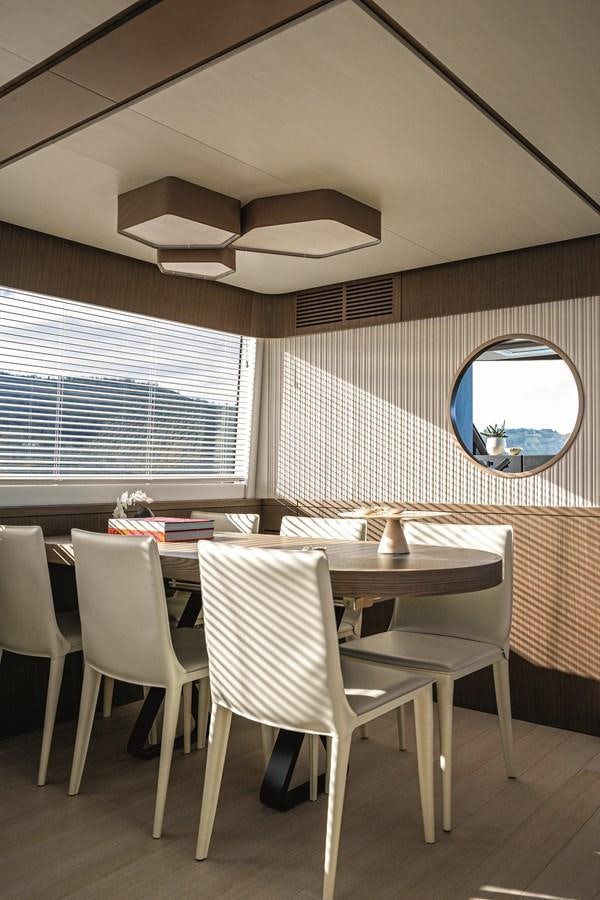 a room with a table and chairs aboard 2023 MAGELLANO 66 Yacht for Sale
