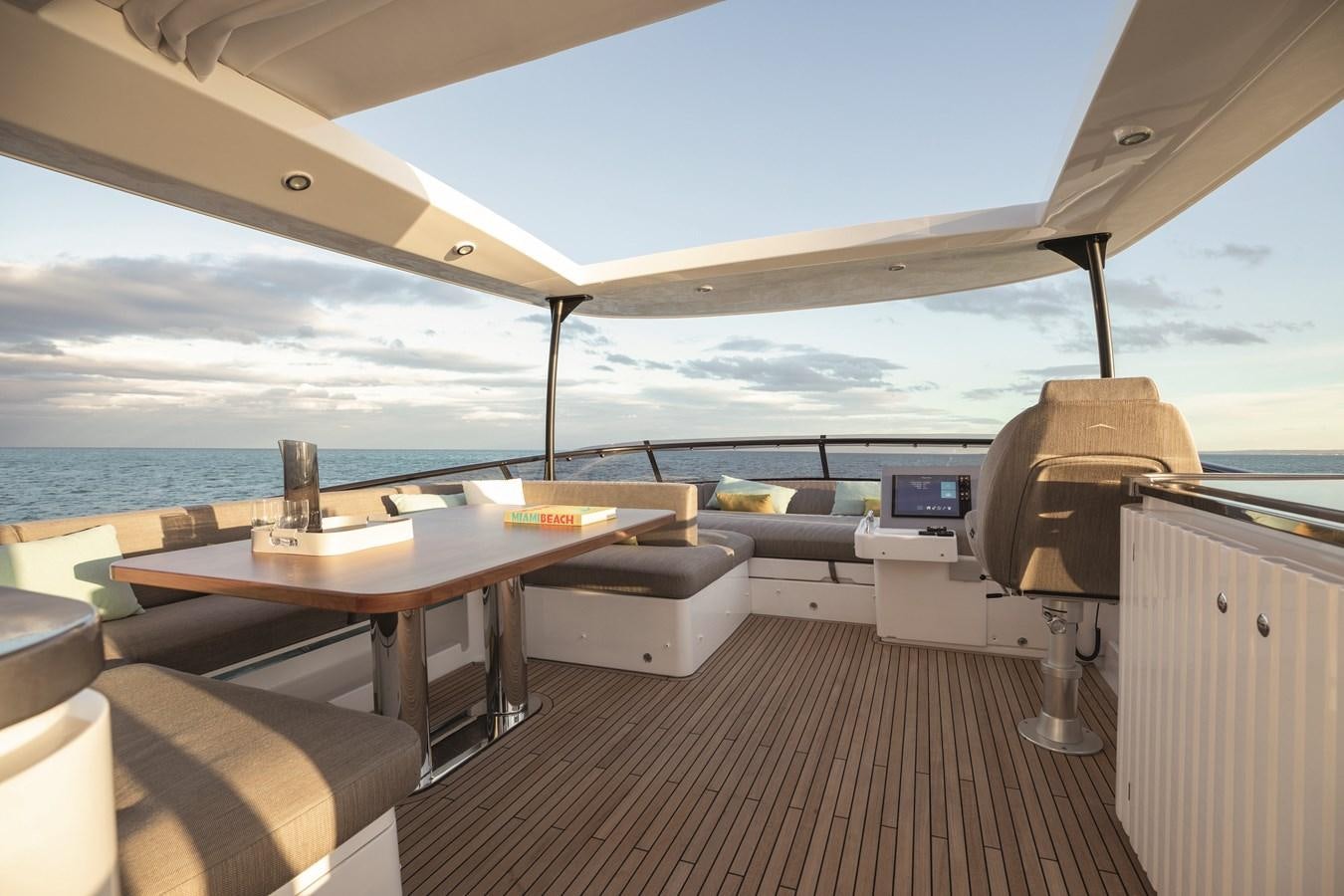 a room with a table and chairs aboard 2023 MAGELLANO 66 Yacht for Sale
