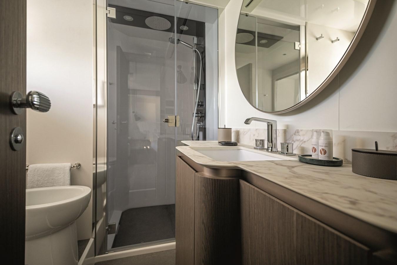 a bathroom with a glass shower aboard 2023 MAGELLANO 66 Yacht for Sale