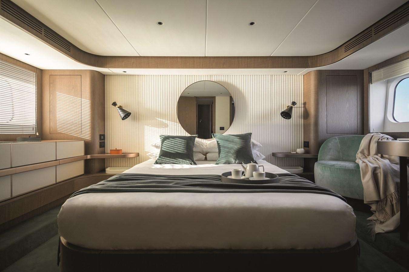 a bed with a black bed spread aboard 2023 MAGELLANO 66 Yacht for Sale