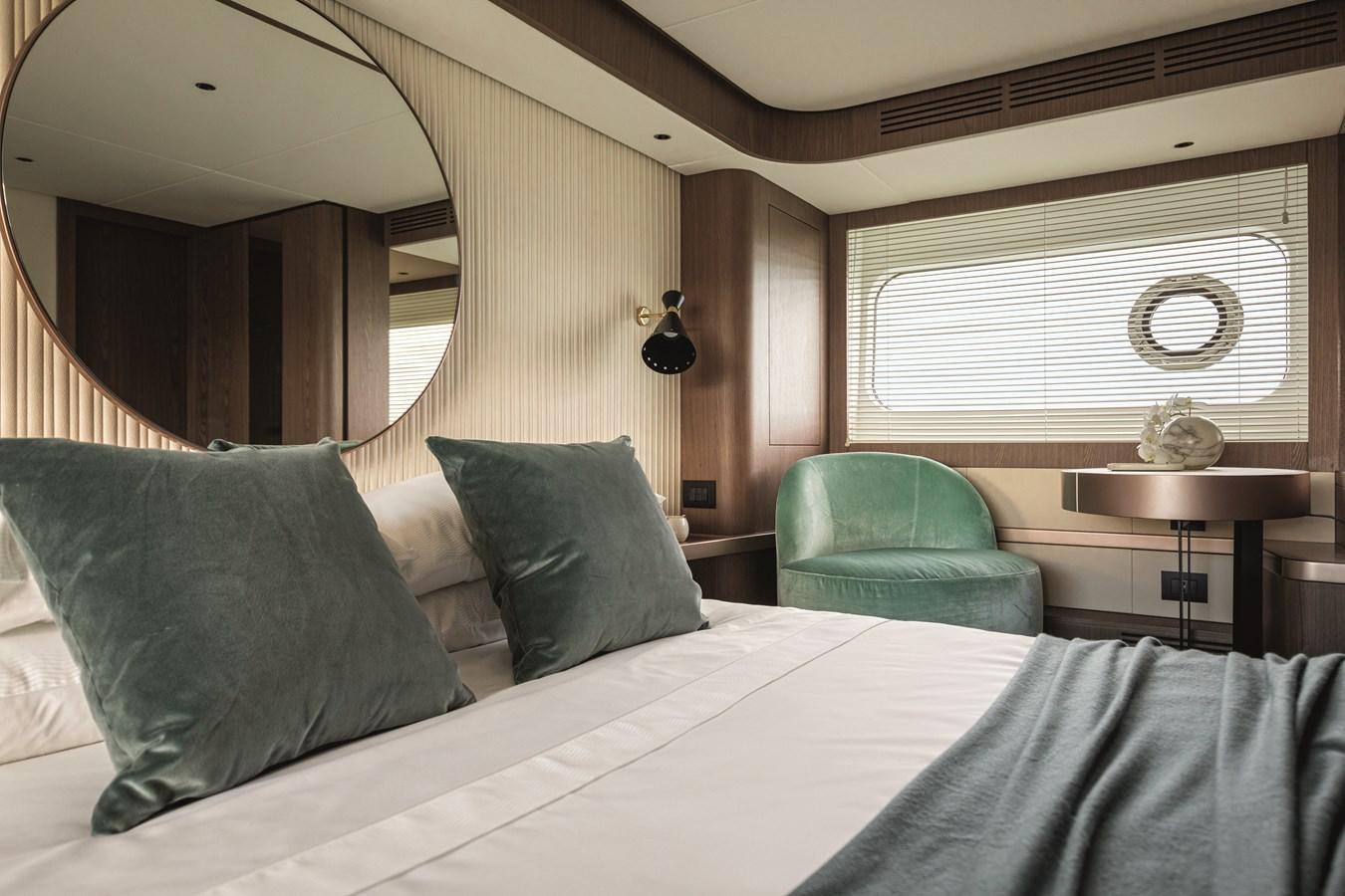 a bed with a white bed spread aboard 2023 MAGELLANO 66 Yacht for Sale