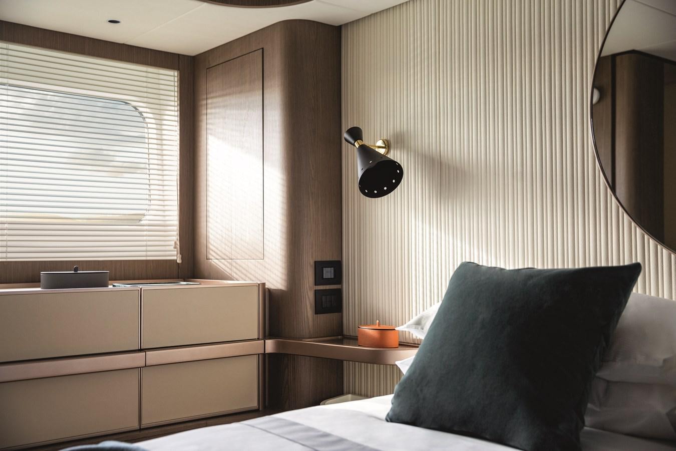 a bed with a lamp on it aboard 2023 MAGELLANO 66 Yacht for Sale