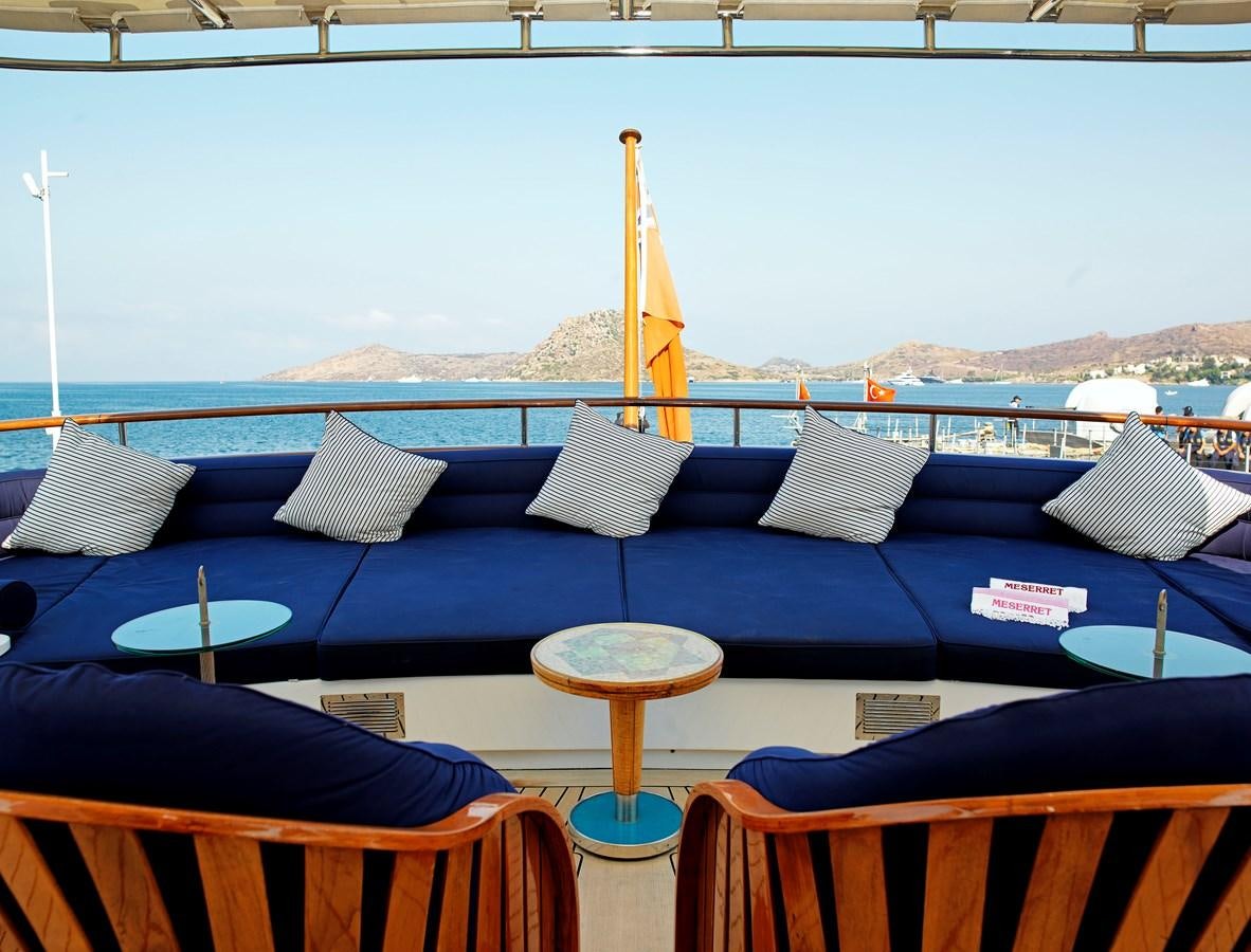 a boat with pillows and a table aboard MESERRET II Yacht for Sale