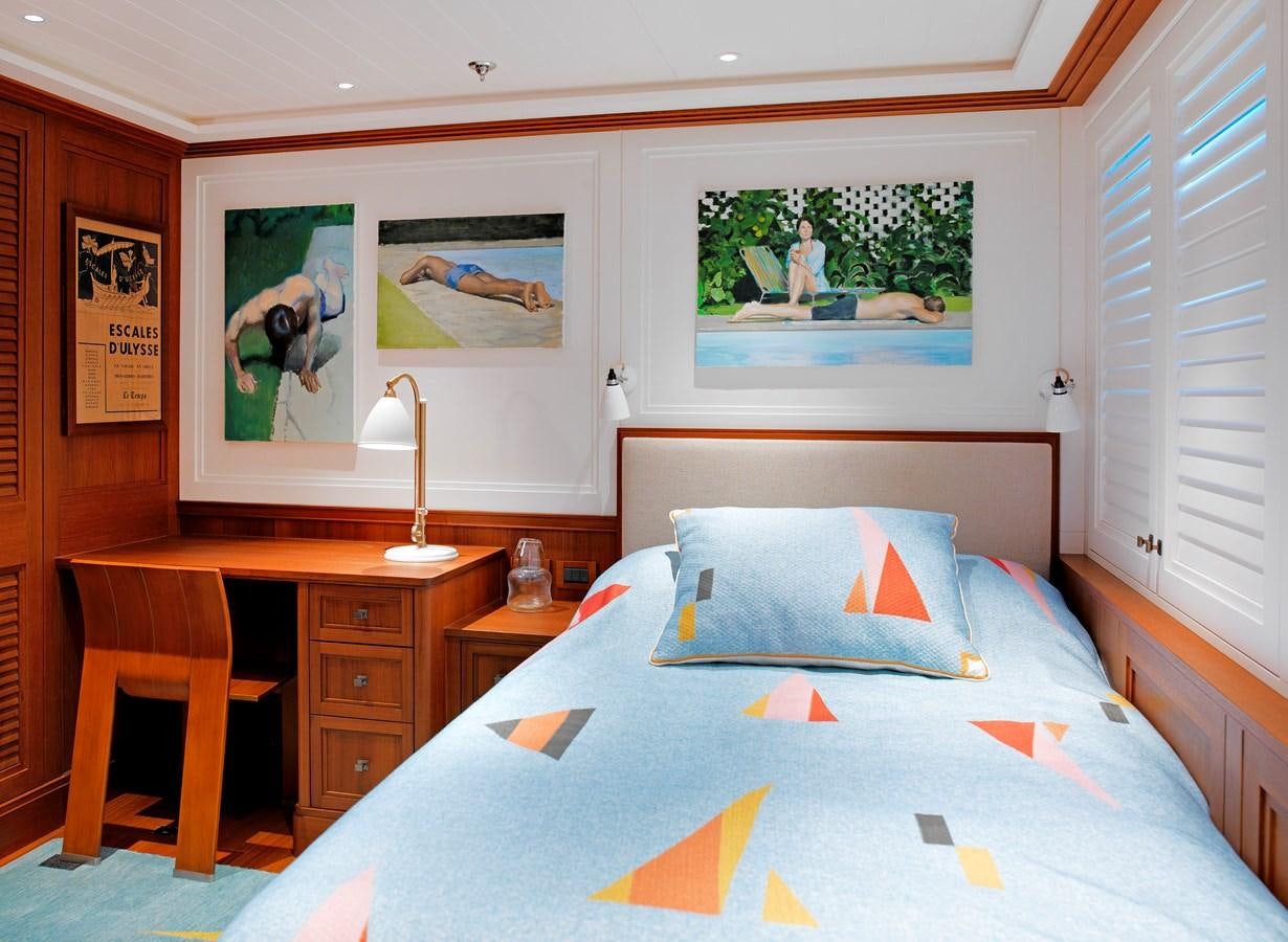 a bedroom with a bed and desk aboard MESERRET II Yacht for Sale