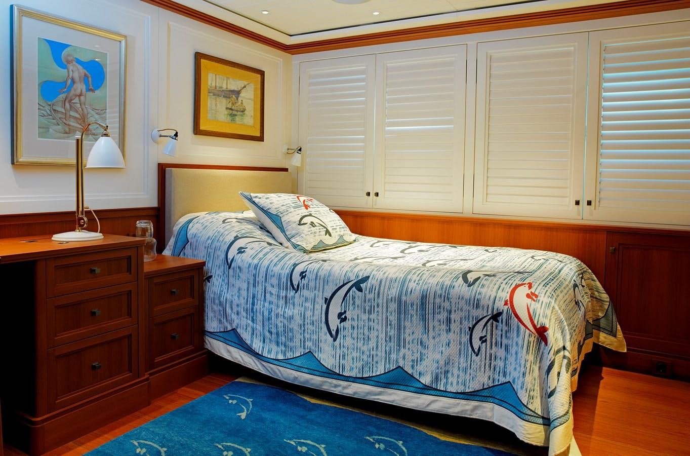 a bedroom with a bed and a lamp aboard MESERRET II Yacht for Sale