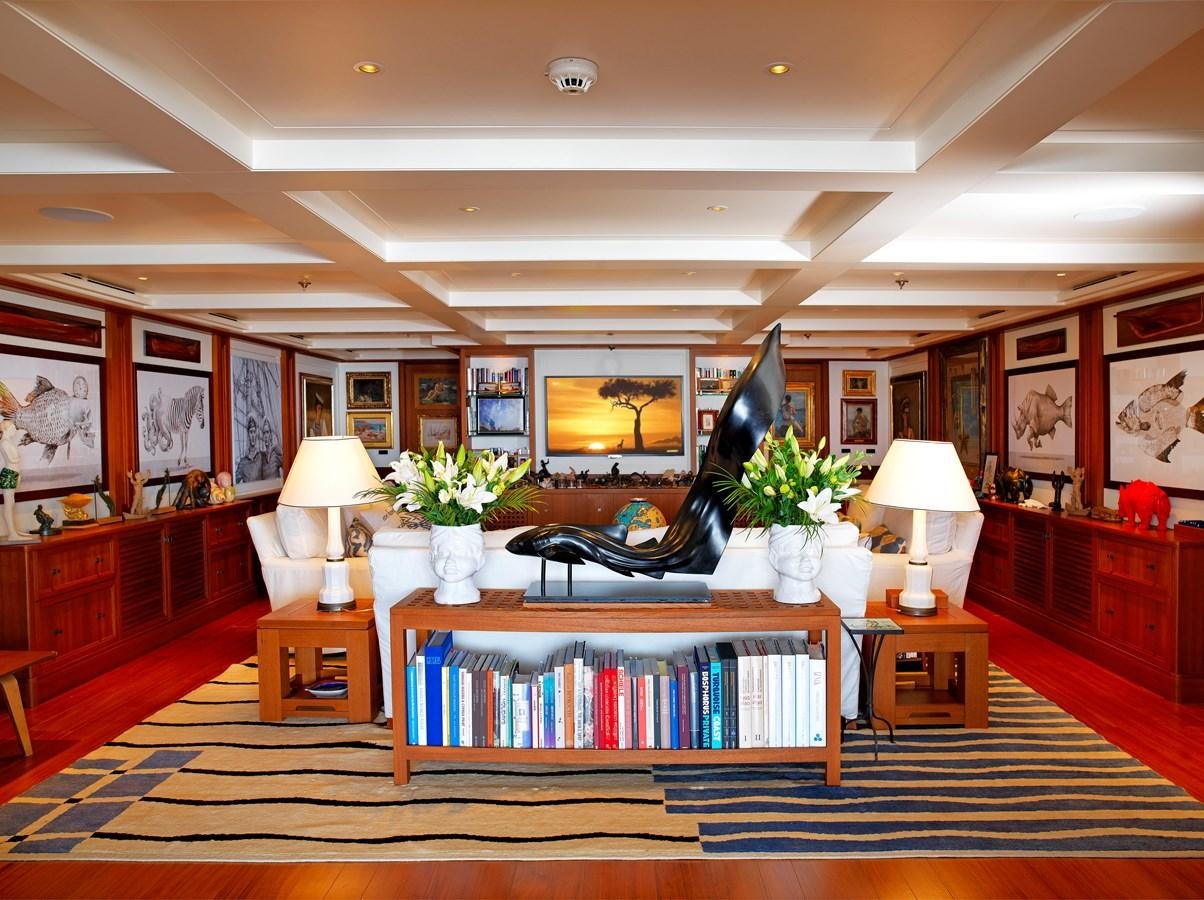 a room with a piano and a lamp on the floor aboard MESERRET II Yacht for Sale