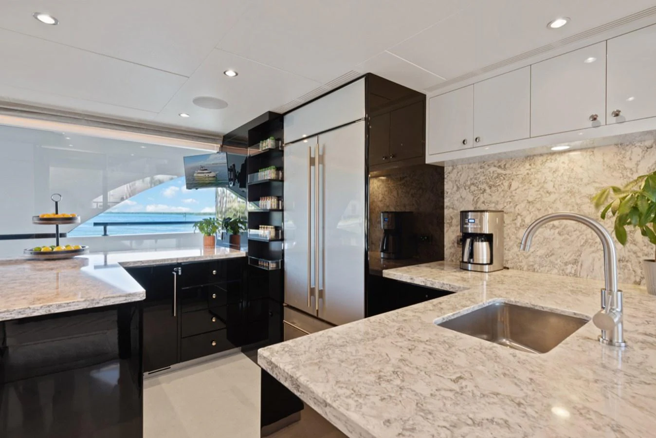 a kitchen with a large island aboard EVERGLADE Yacht for Sale