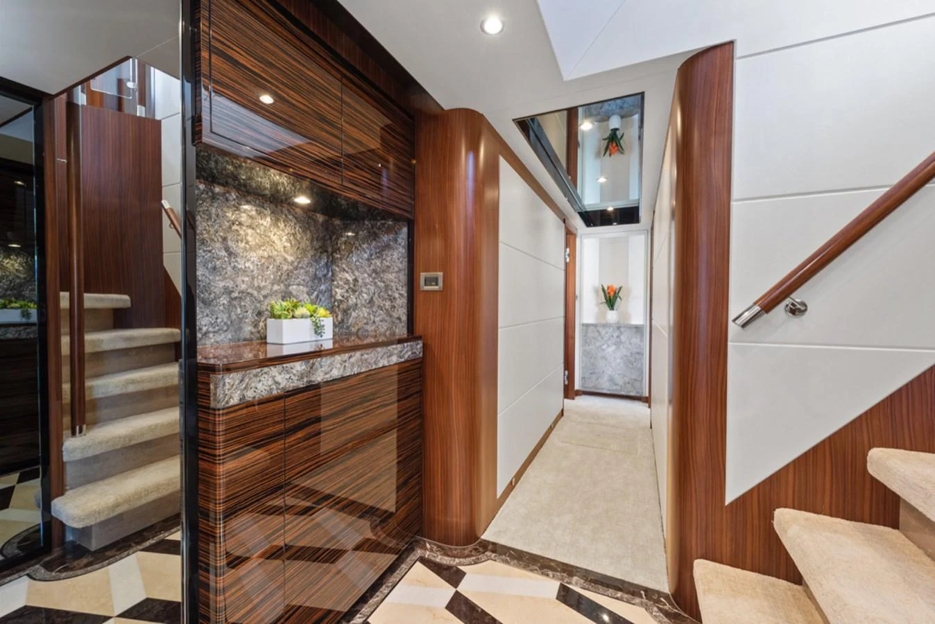 a room with a wood staircase and a wood railing aboard EVERGLADE Yacht for Sale