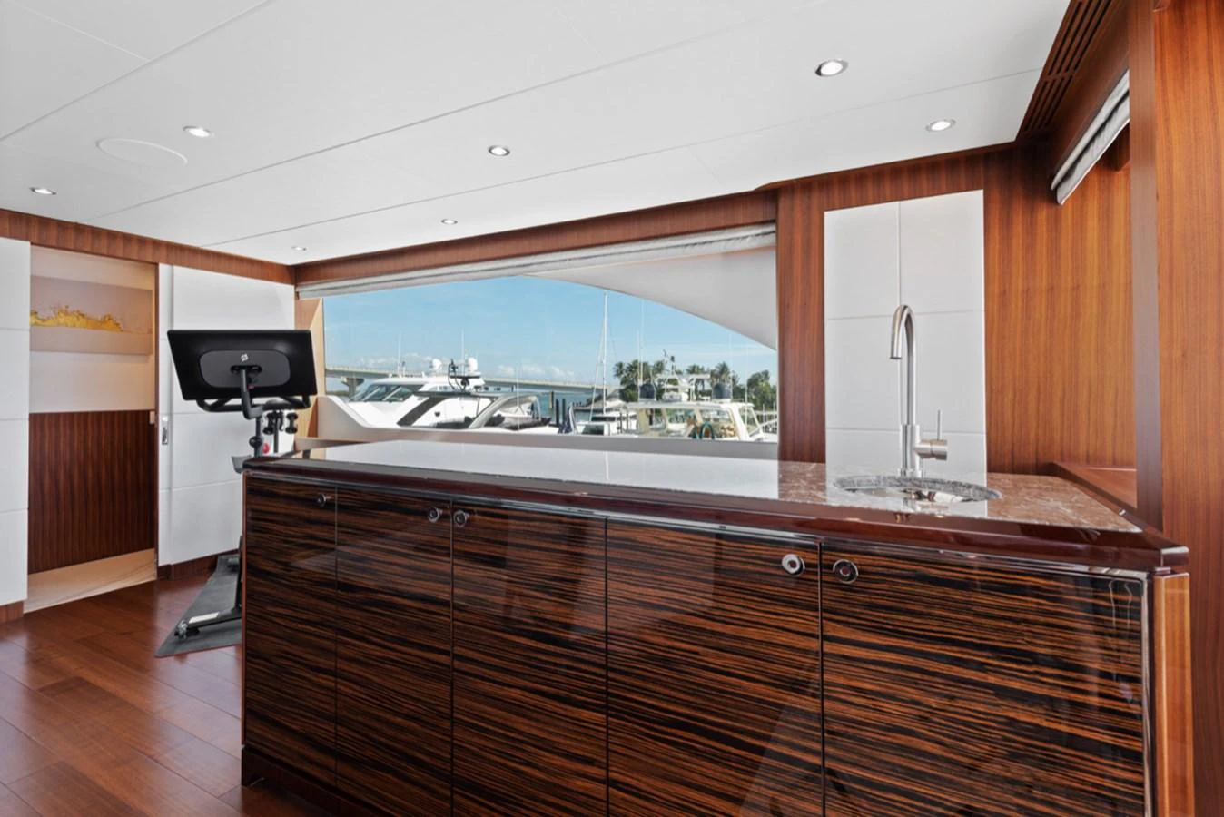 a kitchen with a large window aboard EVERGLADE Yacht for Sale