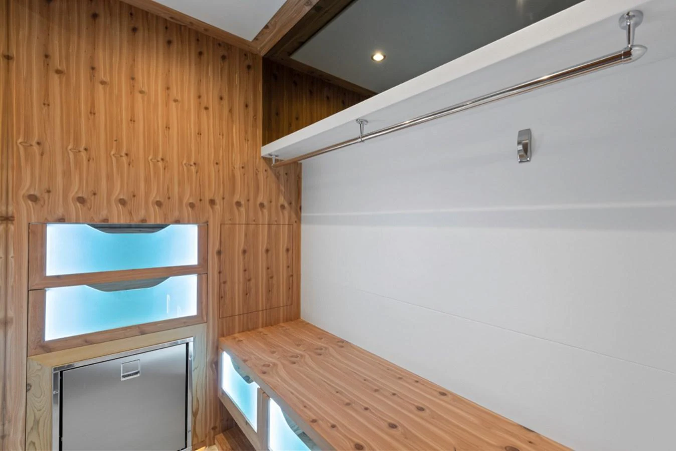 a room with a wood floor and a white wall with a wood paneling and a white door aboard EVERGLADE Yacht for Sale