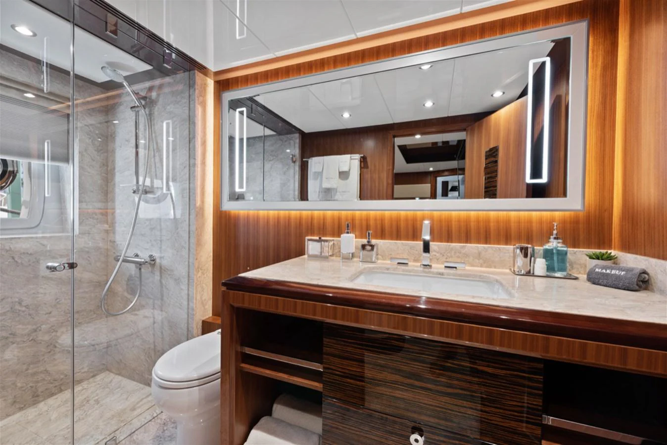 a bathroom with a glass shower aboard EVERGLADE Yacht for Sale