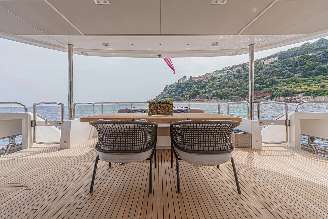 a table and chairs on a patio aboard AVALON Yacht for Sale